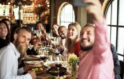 group of friends posing for a picture during a group dinner